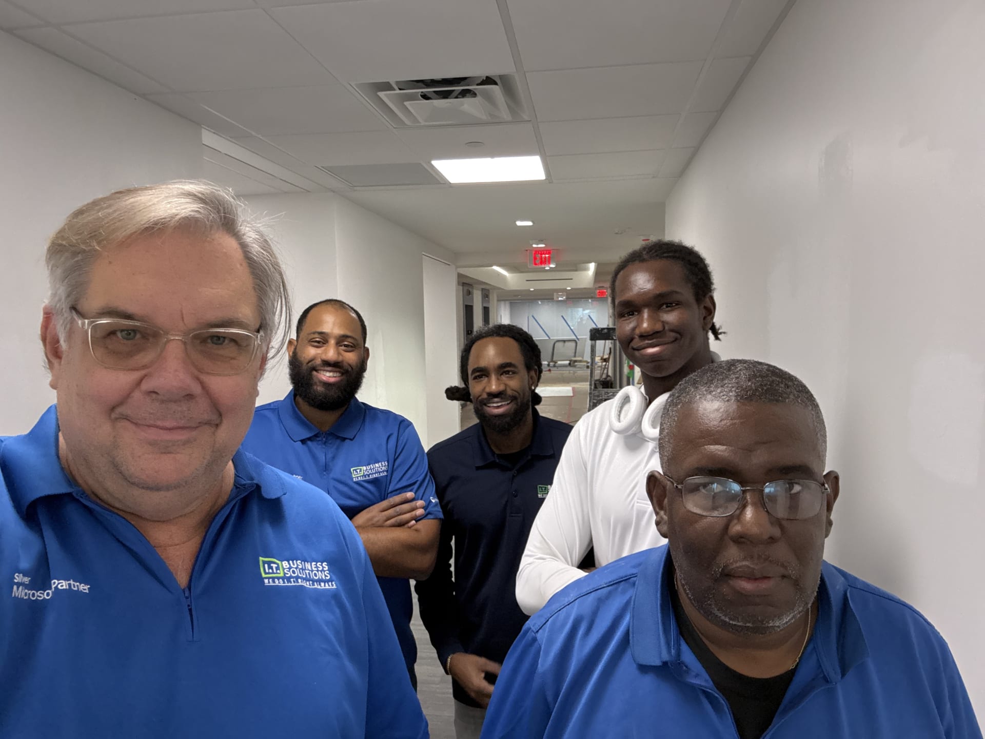 IT Business Solutions team members in blue company polos